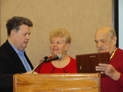 Mayor Bill Hendrick congratulated Paul Sci and presented him with a citation from the Village of Lynbrook as his wife, Katherine, looked on.