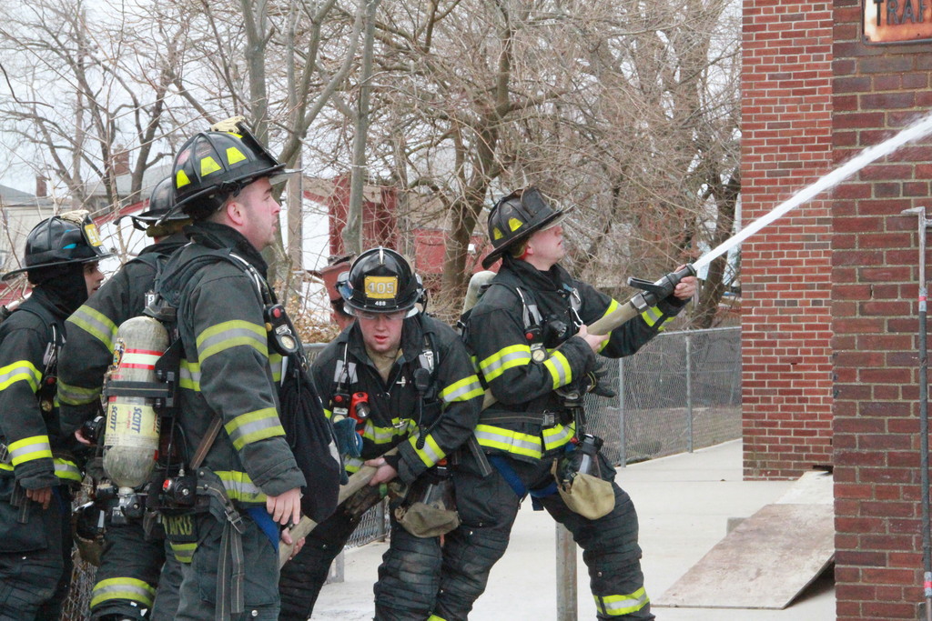 East Rockaway firefighters extinguish a small fire at the high school. No students were attending.