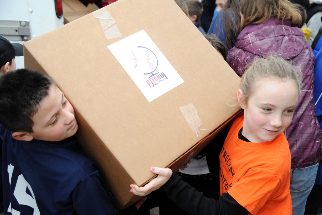 Two little leaguers carried a box bigger than them!