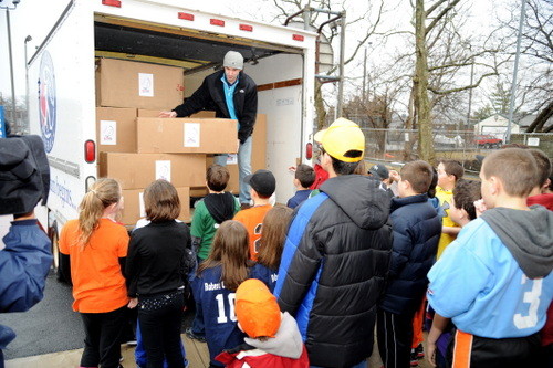 Everyone pitches in to help unload the truck.