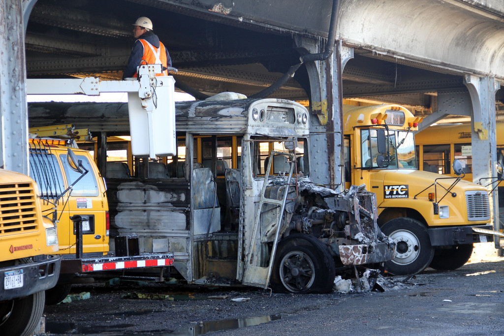 An MTA inspector survey the Long Island Rail Road bridge where a bus at Veterans Transportation caught fire early Wednesday morning. Photo by Susan Grieco/Herald
