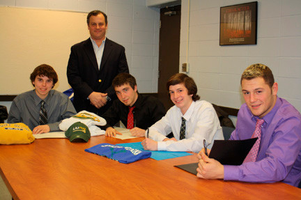 Lynbrook High School seniors 
Robert Steinert, left, Michael Andrews, Nicholas LoCicero and Matthew Mott will be participating in college lacrosse. They are pictured with coach William Leighley, standing.