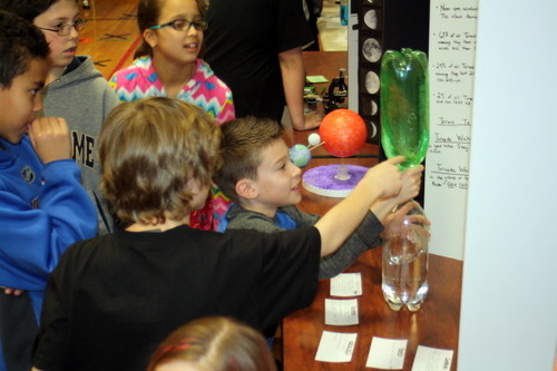 Fifth-grader Peter Pagan (right) attracted a crowd as he demonstrated the properties of a tornado at the West End School science fair in Lynbrook.