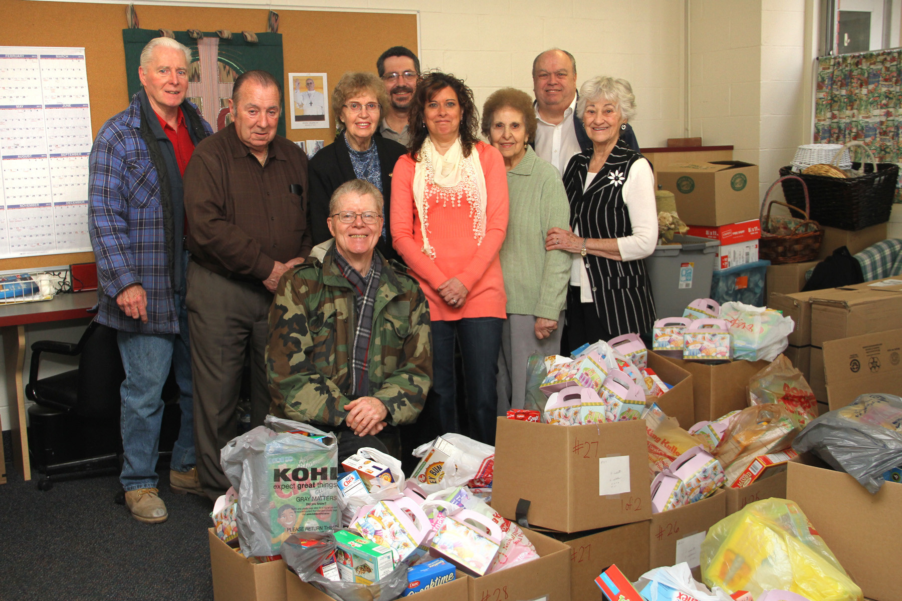 Blessed Sacrament Parish Outreach Center director Judy Miccio, fourth from right, is joined by volunteers Dave McKean, Charles McLaughlin, James Cunningham, Nancy Farrington, Mark Daley, Mary Gluck, James Riley and Angelina Bonfiglio who put baskets together for needy families in Valley Stream.