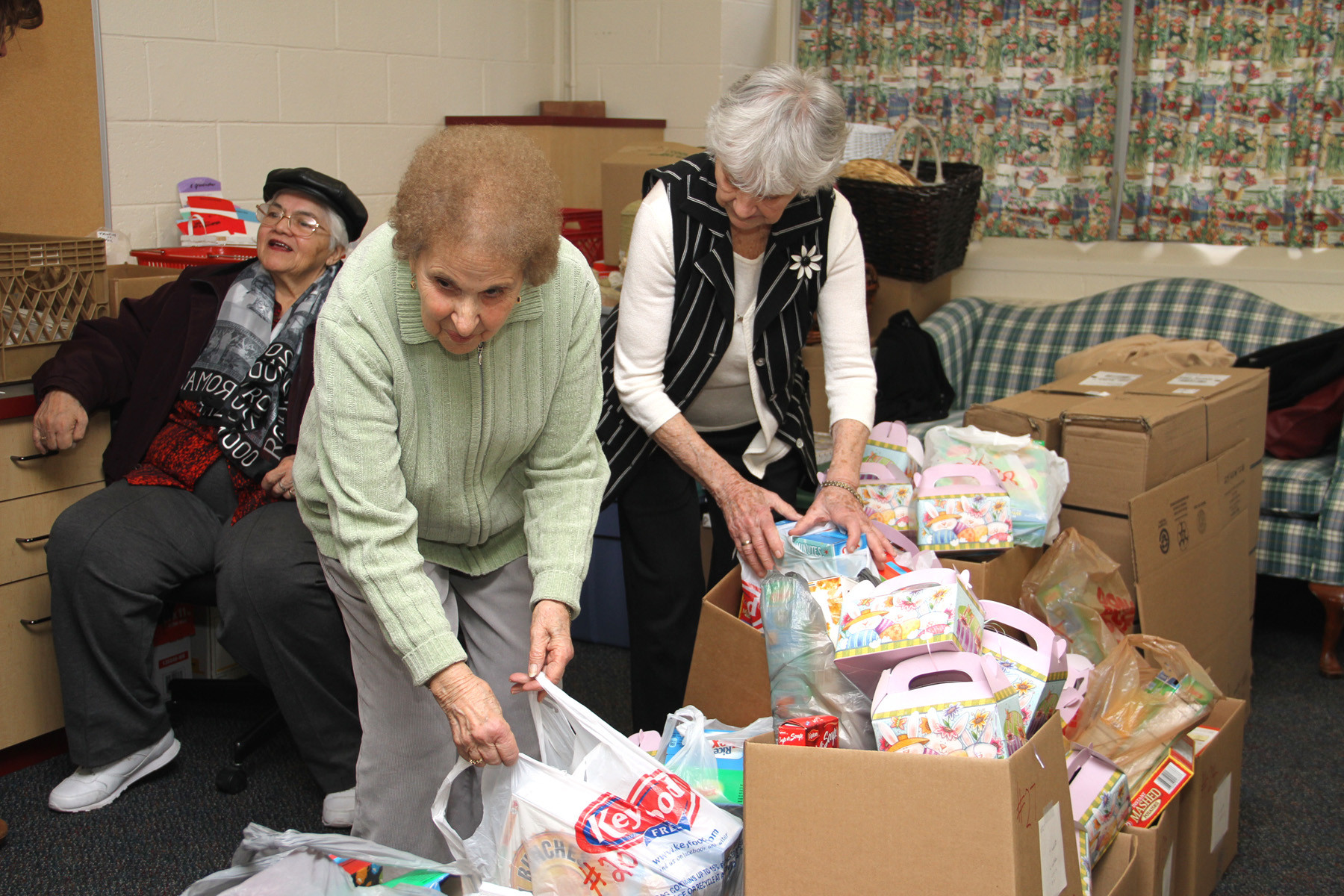Parishioners Mary Gluck and Angelina Bonfiglio sorted through the boxes of food.