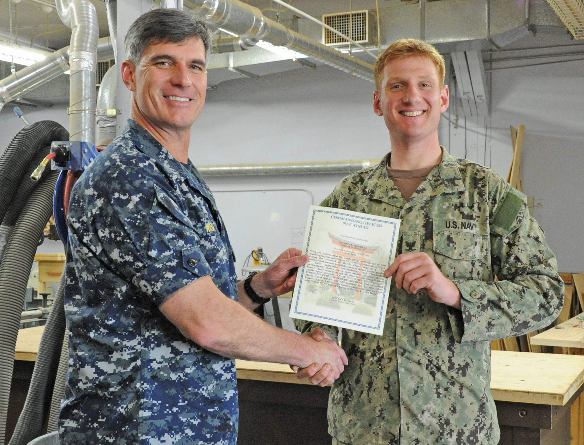 Skoblicki, right, received a letter of commendation from Naval Air Facility Atsugi Commanding Officer Capt. Steven Wieman in recognition of his selection as Sailor of the Week.