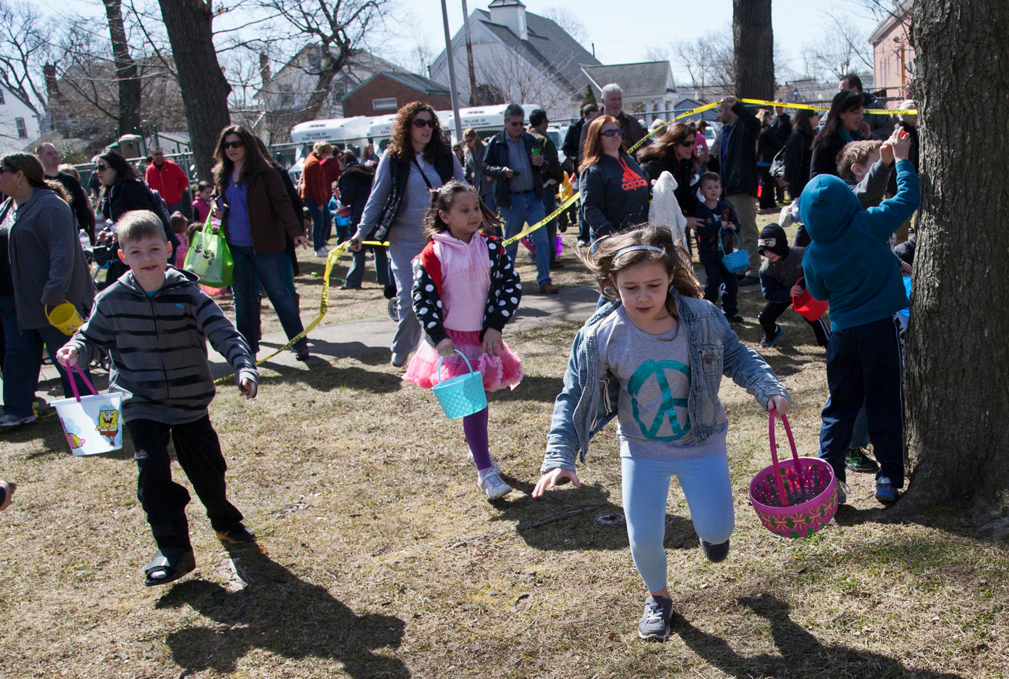 And they’re off! Children raced to pick up the colorful, scattered eggs.