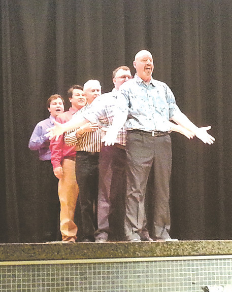 The men rehearse one of their numbers.