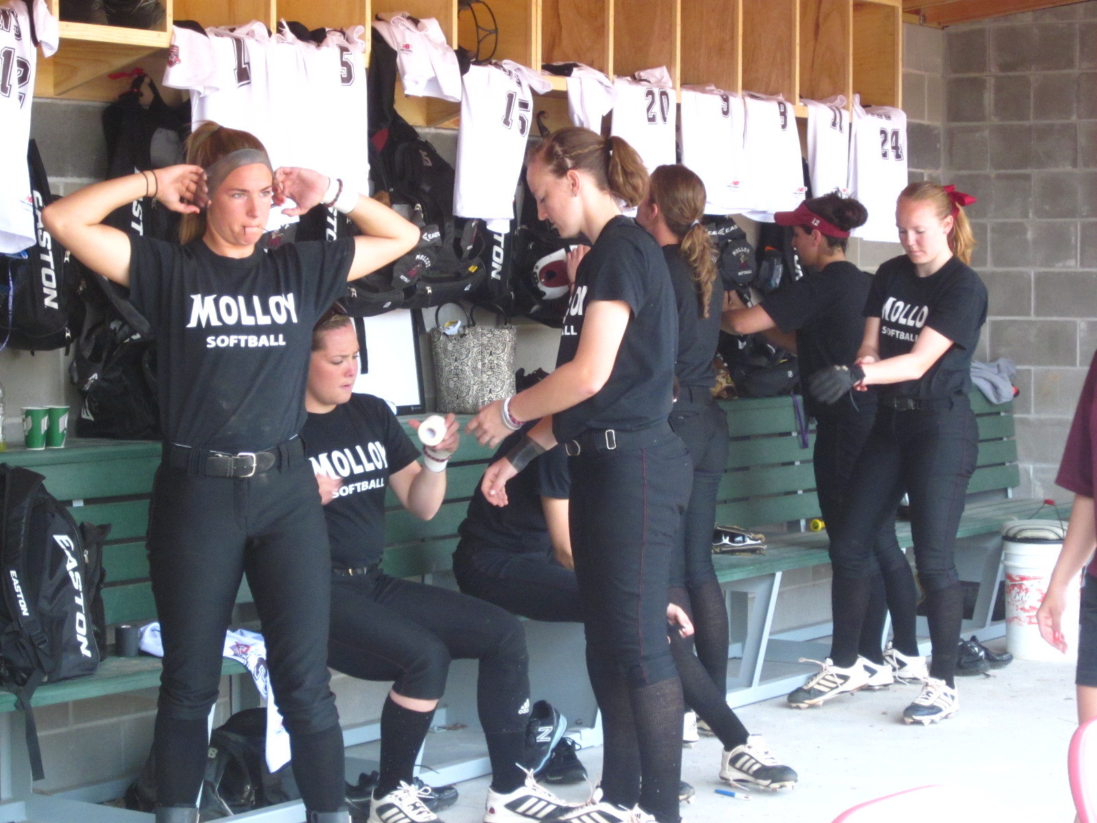 The Lady lions geared-up and stretched in their new dugout.