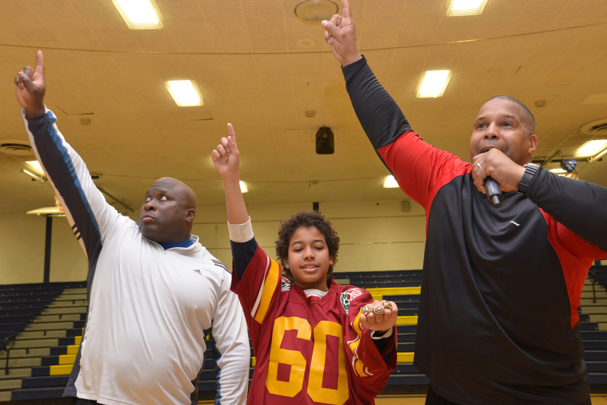 Clarence Lee, left, Ayden Steward and Keith Davis, a former New York Giant, at BHS during the Winners Inc. presentation. Ayden was wearing a number of the football players’ championship rings at the closing of the 
assembly. The event was sponsored by Brian Curran and Dean Skelos.