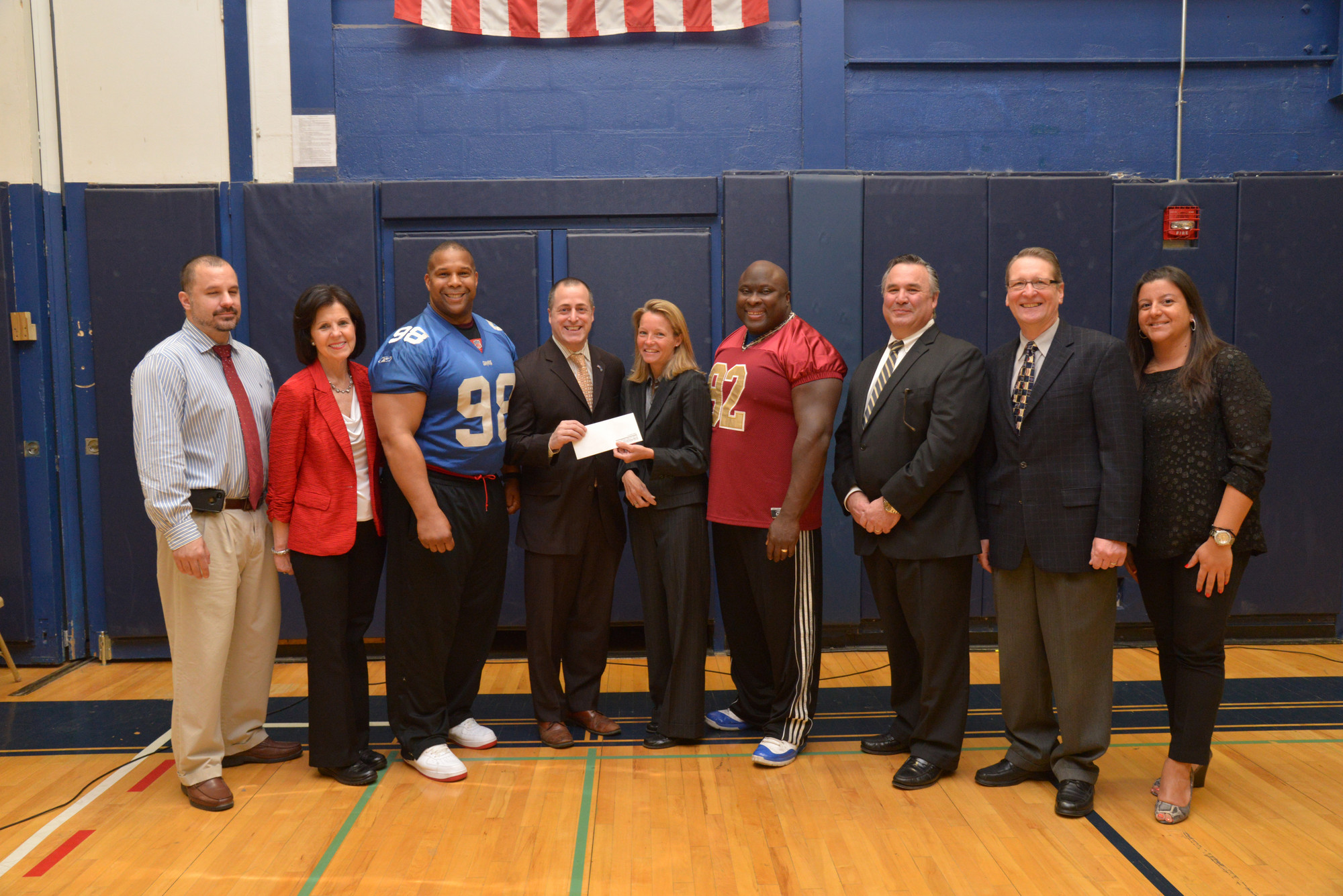 Ed Ramirez, BHS Athletic Director, left, with Pat Banhazl (School to Careers administrator), Keith Davis, Assemblyman Brian Curran, Molloy College Athletic Director Susan Cassidy-Lyke, Clarence Lee, Jim Scannell, Richard Miskiewicz (BHS assistant principal) and Helen Kanellopoulas. Molloy was presenting a check to BHS.