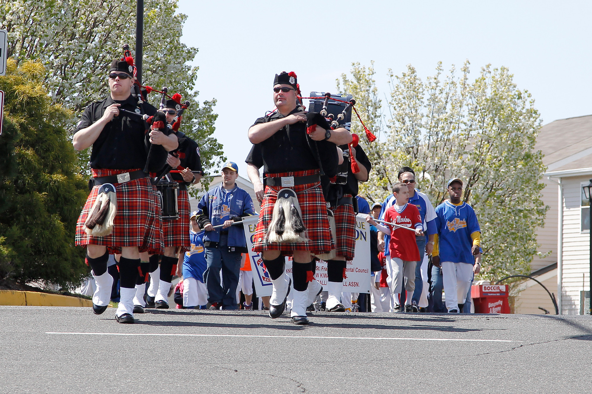 The Nassau County Firefighters Bag Pipes and Drum Corps and the Challenger Division players led the East Meadow Baseball Softball Association parade as it entered the ball field complex on Merrick Avenue.