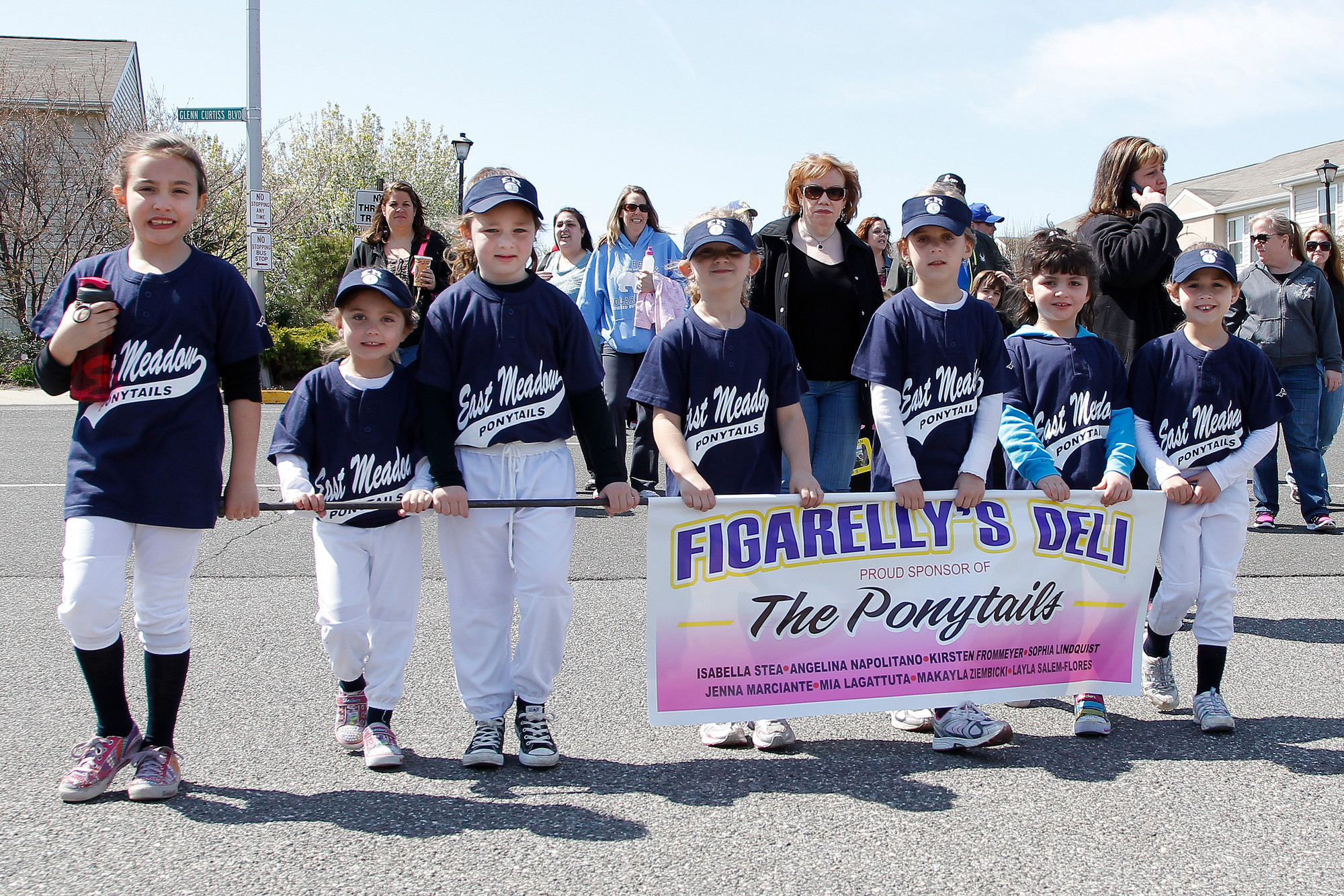 The East Meadow Ponytails team, sponsored by Figarelly’s Deli, was one of many teams who gathered together and marched during the East Meadow Baseball Softball Association’s annual parade.