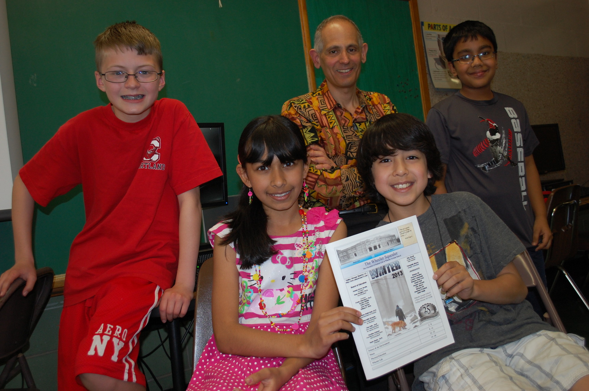 Wheeler Avenue School fifth-grader teacher Guy Jacob has been publishing the Wheeler Squealer for the pat 25 years. He is joined by members of this year’s reporting staff, from left, Michael Ott, Solani Dutt, Vito Oliveri and Jonathan Prashad.
