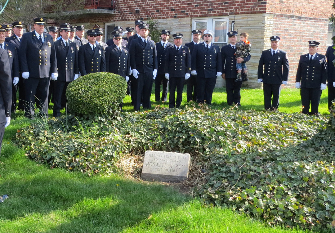 LFD members at the stone commemorating crossing guard Rosalie Roy.