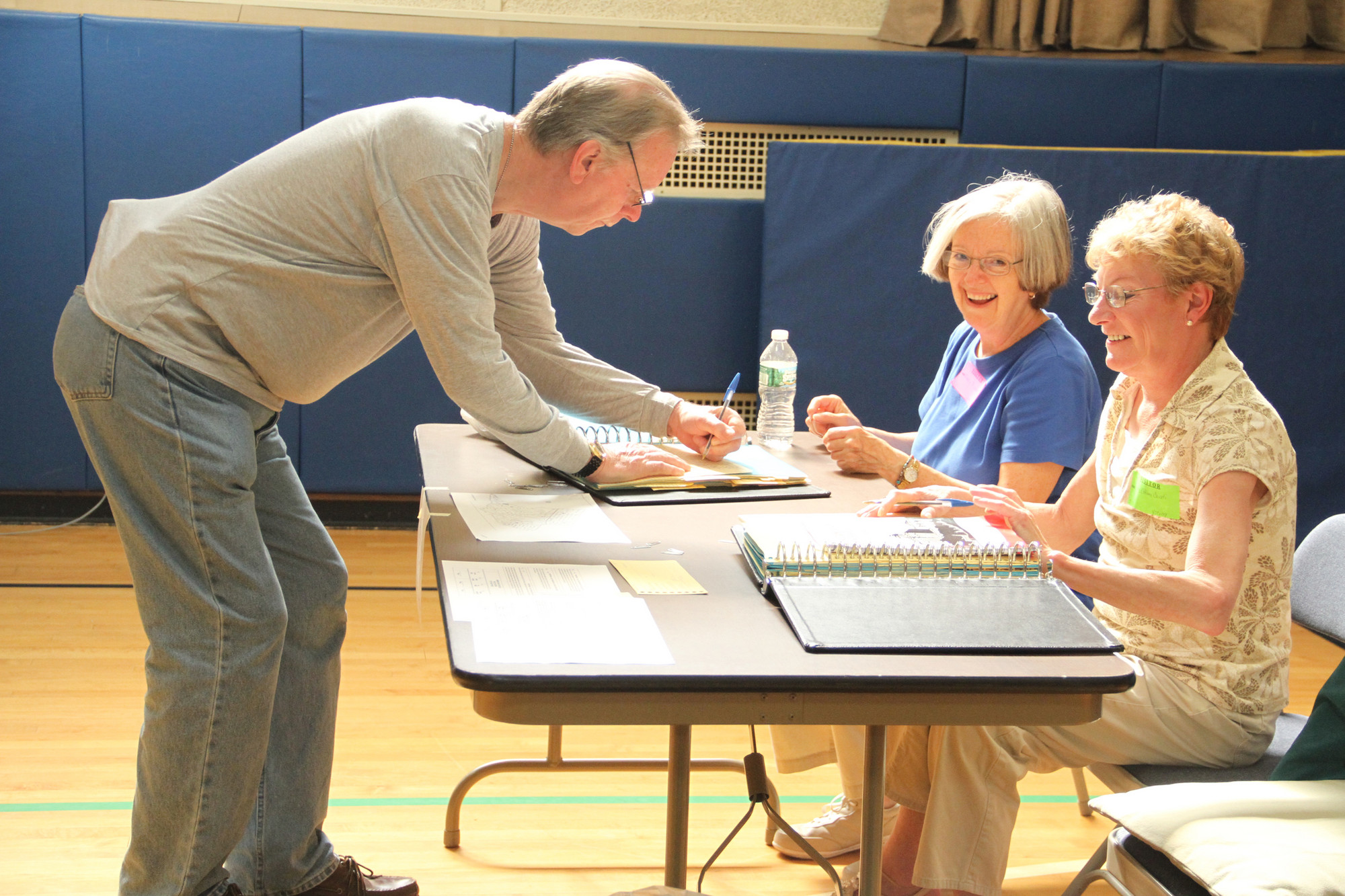 School Election workers Nancy Pirodsky and Kathleen Caiati got William Wheelwright signed in to vote Tuesday morning at the William L. Buck School where District 24’s $28.7 million budget was on the ballot.