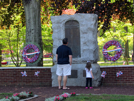 Residents read the Wall of Honor at Memorial Park before the parade began.