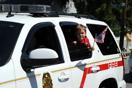 Ryan Salveson, 4, brandished the American flag while riding in the parade.