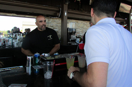 John gabelli took a drink order at the outdoor bar.
