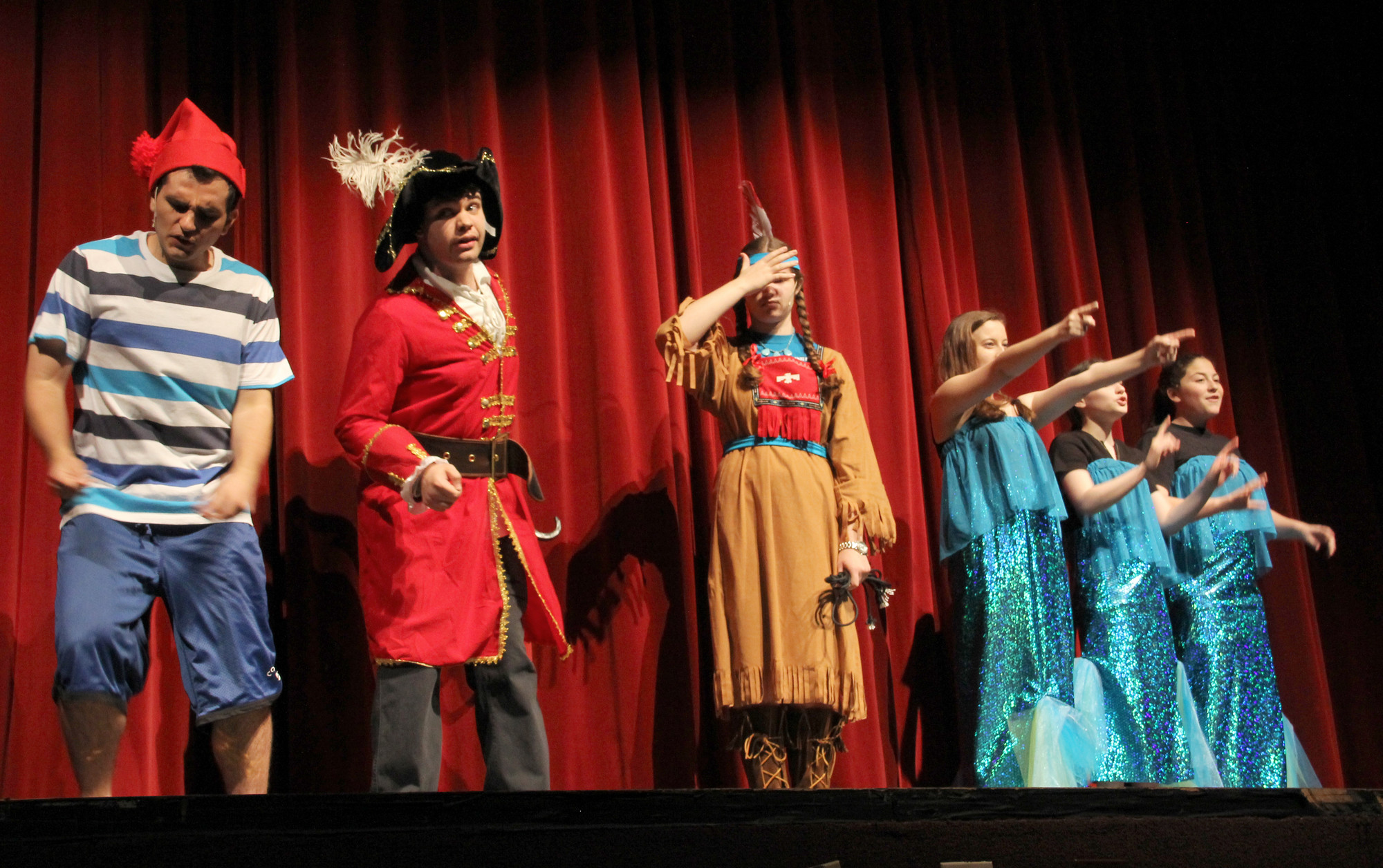 Smee (Rick Cisario) left, and Hook (Bryan Nesdill) who helped write the play, in a scene called “The Capture of Tiger Lily.” They are pictured on stage with Tiger Lily (Kyra Ganzi-Barnes) and the Mermaid singers.