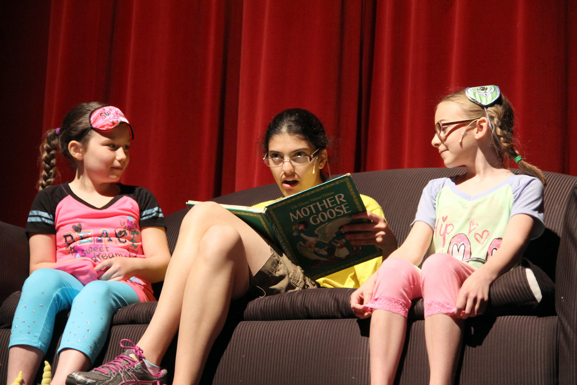 Elizabeth, center, played by Josie DeMarco reads a bed time story to Victoria, Lila Naccari, and Julia, Lanie Prendergast.