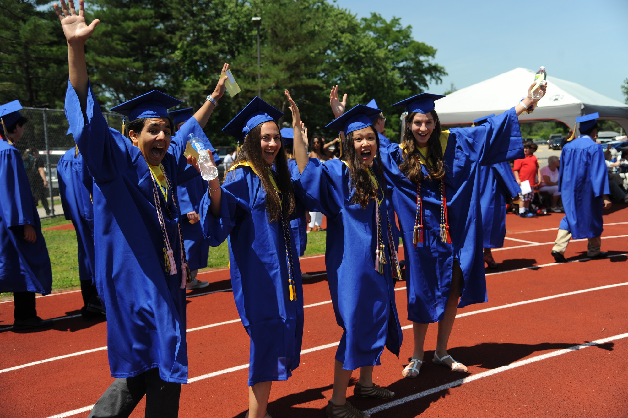 As students entered the football field to begin the graduation ceremony on Sunday, these four excited seniors expressed their excitement to be among the East Meadow High School graduating class of 2013.