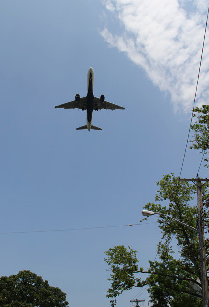 A plane flies over Southwest Nassau as it approaches JFK.