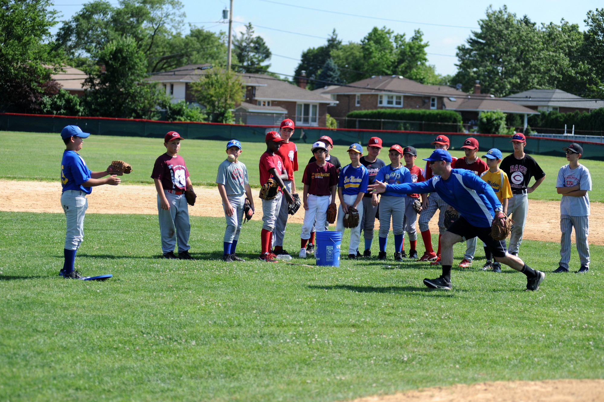 Will Palmer, a guidance counselor in the East Meadow School District and a coach of Clarke’s junior varsity team, showed kids the fundamentals during the Creative Arts Program of East Meadow’s summer baseball camp.
