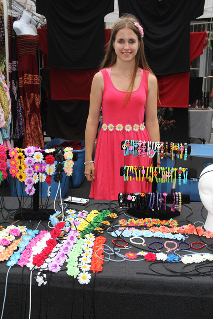 Amy Herweg, of Hot Bracelets, stands behind her colorful booth.