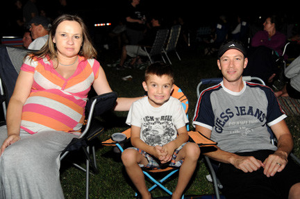 Maggie Zenie, left, sat back to take in the night’s sights and sounds with Liam, 5, and Michael.