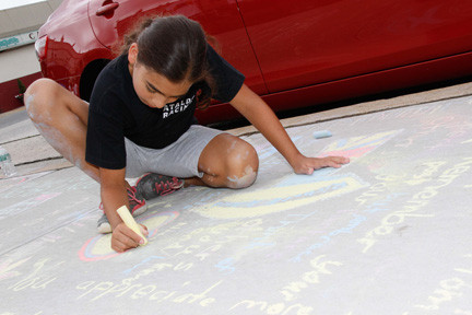 Nicole Cataleo, of East Rockaway, got down and dirty to draw her picture on the sidewalk outside Village Hall.