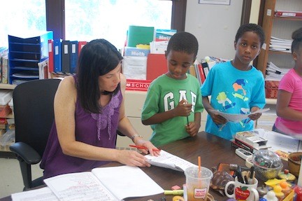 Carrie Richman reviews an assignment for her incoming third-grade students.