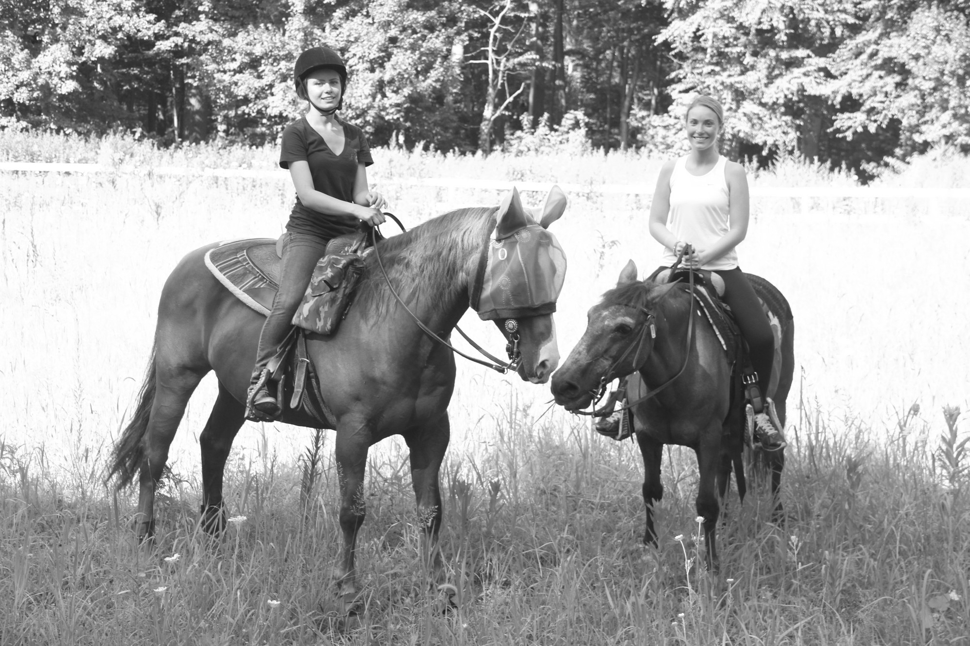 Alina Semenova on Jesse and Amanda McKelvey on Layla gave their mounts a rest at the butterfly meadow.