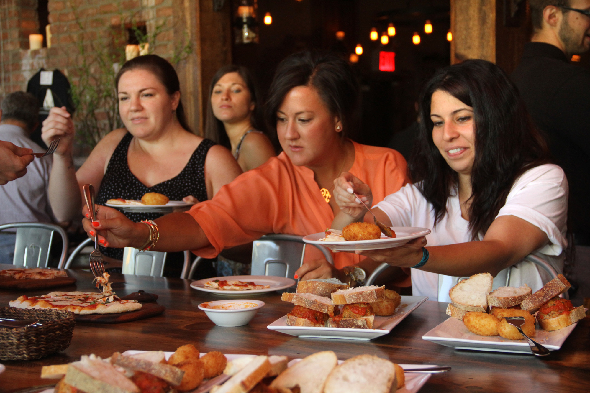 Kristen Melega, Christine Comer and Taline Kharhatoorian help themselves to appetizers.