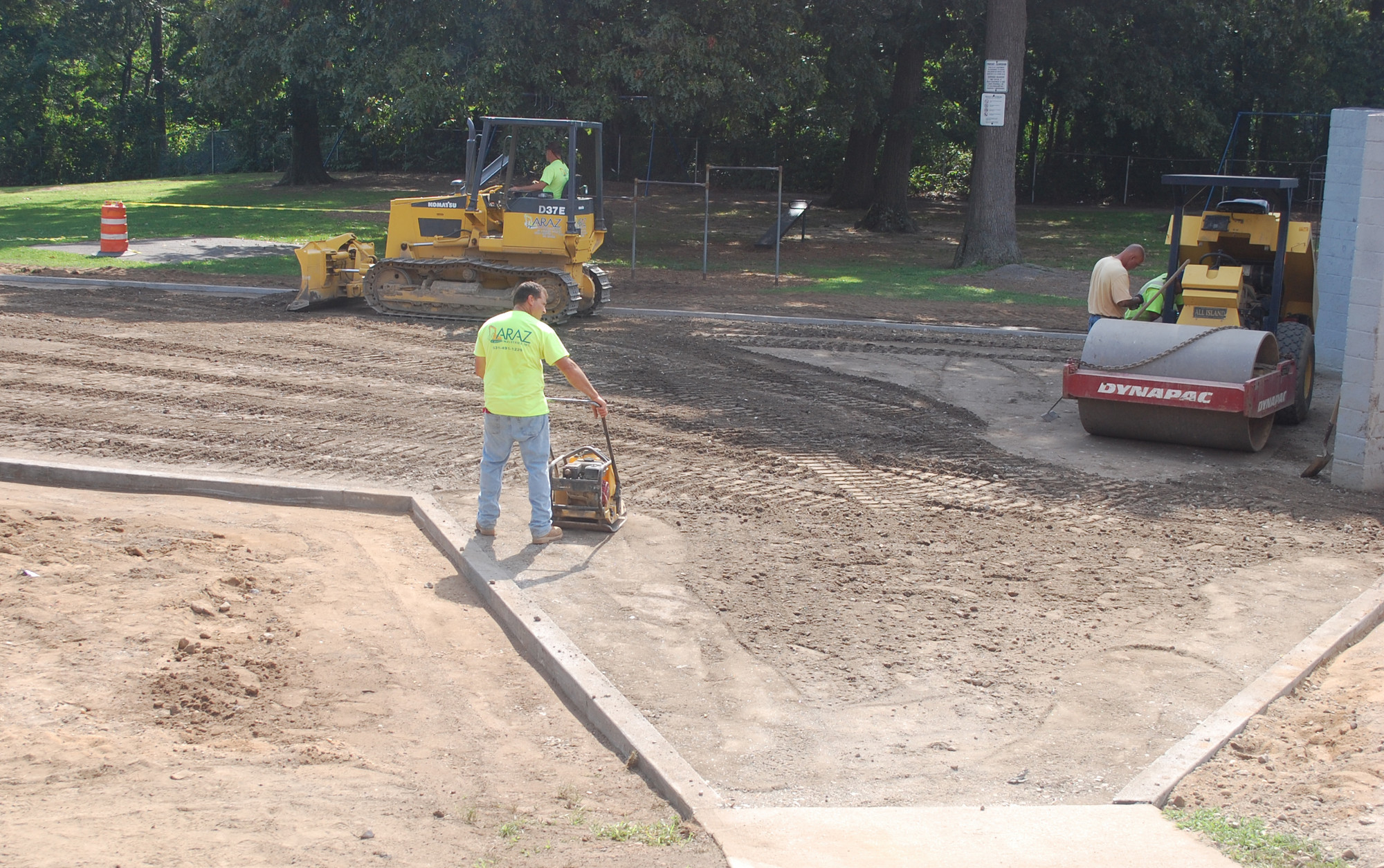 Crews prepare the handball court for paving at the Howell Road School, one of several capital projects ongoing this summer in District 13.