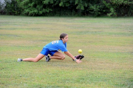 Nicole Morreale dove to catch a fly ball during a recent East Meadow Fillies team practice. The group of 12 girls have been playing together for three years.