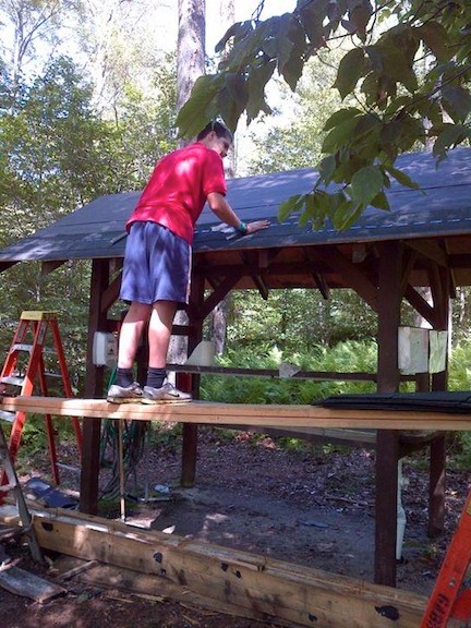 Owen Clark helping with wash station roof repairs.