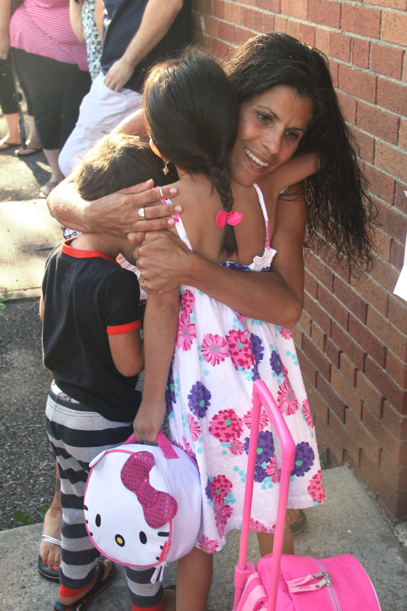 Isabella Burmann got a big hug from her mother, Cecilia, and little brother, Philip, before the first day of school at Willow Road.
