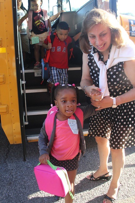Kaitlin Hamilton was greeted by Willow Road School Principal Stephanie Capozzoli as she emerged from the bus for her first day of kindergarten.