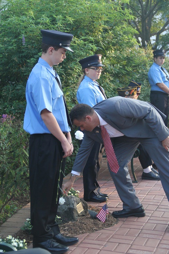 Charles Horn lays a flower on brother Michael's memorial stone.