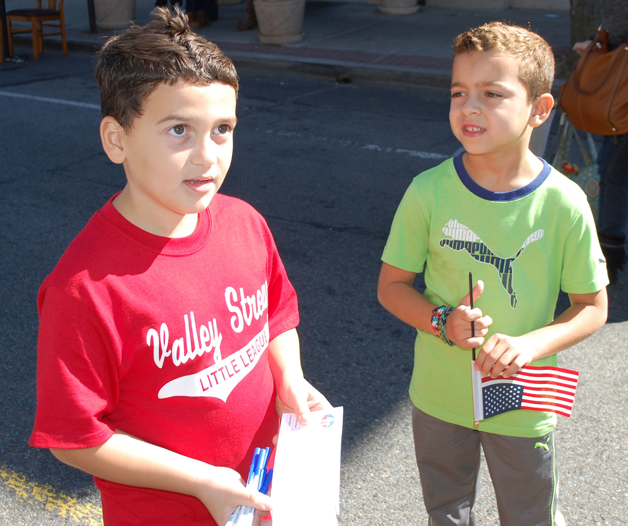 Nicholas Baez, 8, left, and Daniel Banach, 6, were signing fairgoers up for a free raffle for a chance to win a jersey from the Valley Stream Little League.