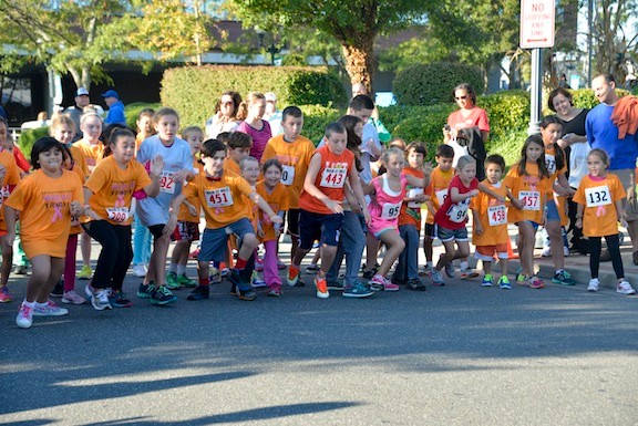The competitors in the fun run take off from the starting line.