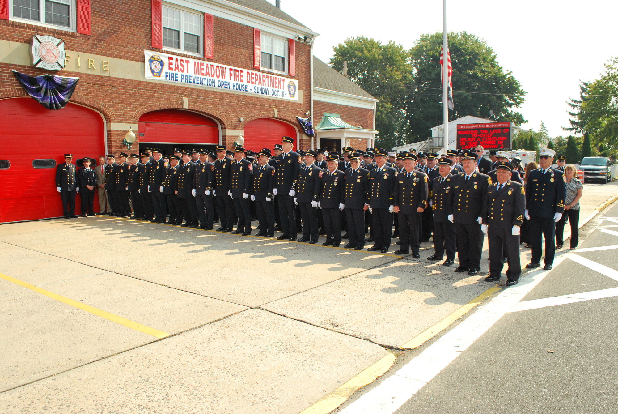 East Meadow Fire Department volunteers stood solemnly outside the East Meadow Avenue firehouse last Friday, as they paid their respects to Nelson Finkelman, a 56-year department veteran who died on Oct. 2.