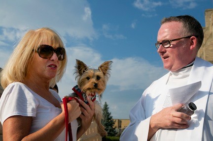 Kathy Martinez and her dog King with Fr. McHugh outside of St. Agnes.