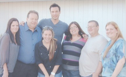 After the filming, Dispirito, center, poses with the family. From left, Kathy Rodonis, Michael,, Jessica Rodonis, Dispirito, Samantha Rosenthal, Michael, Jr., and Gail Rodonis.