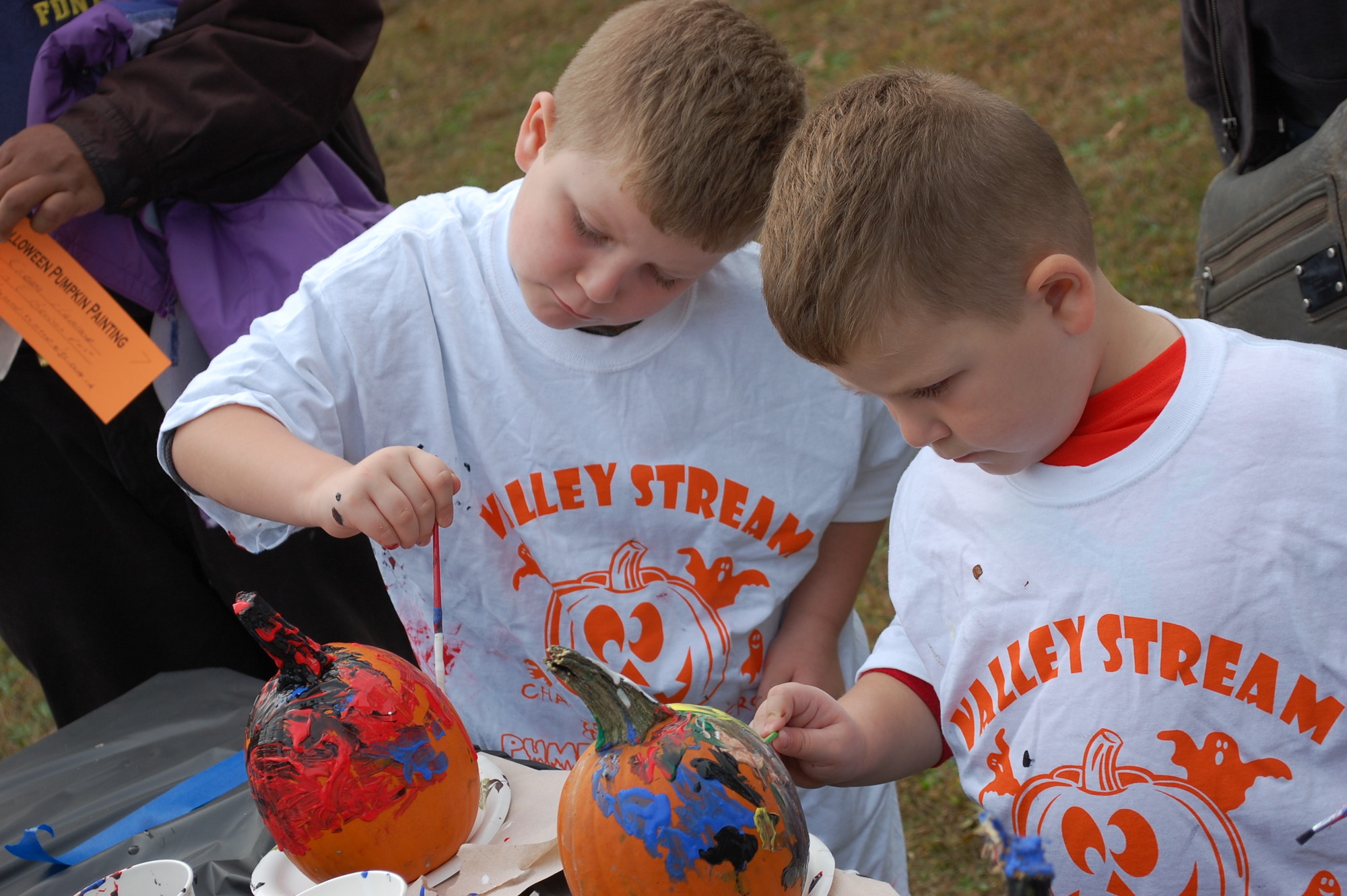 Very little orange could be found once brothers Antonio Casoria, 6, left, and Dominick, 5, got done with their creations at the village