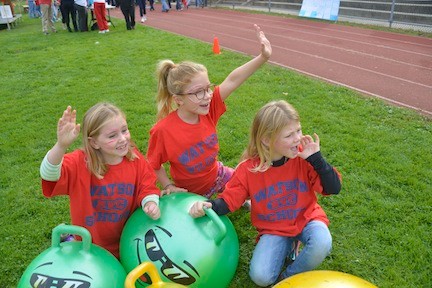 Katherine Ahern, left, Kyla Murphy and Morgan Harloff, all 7, cheered on the walkers from the sidelines.