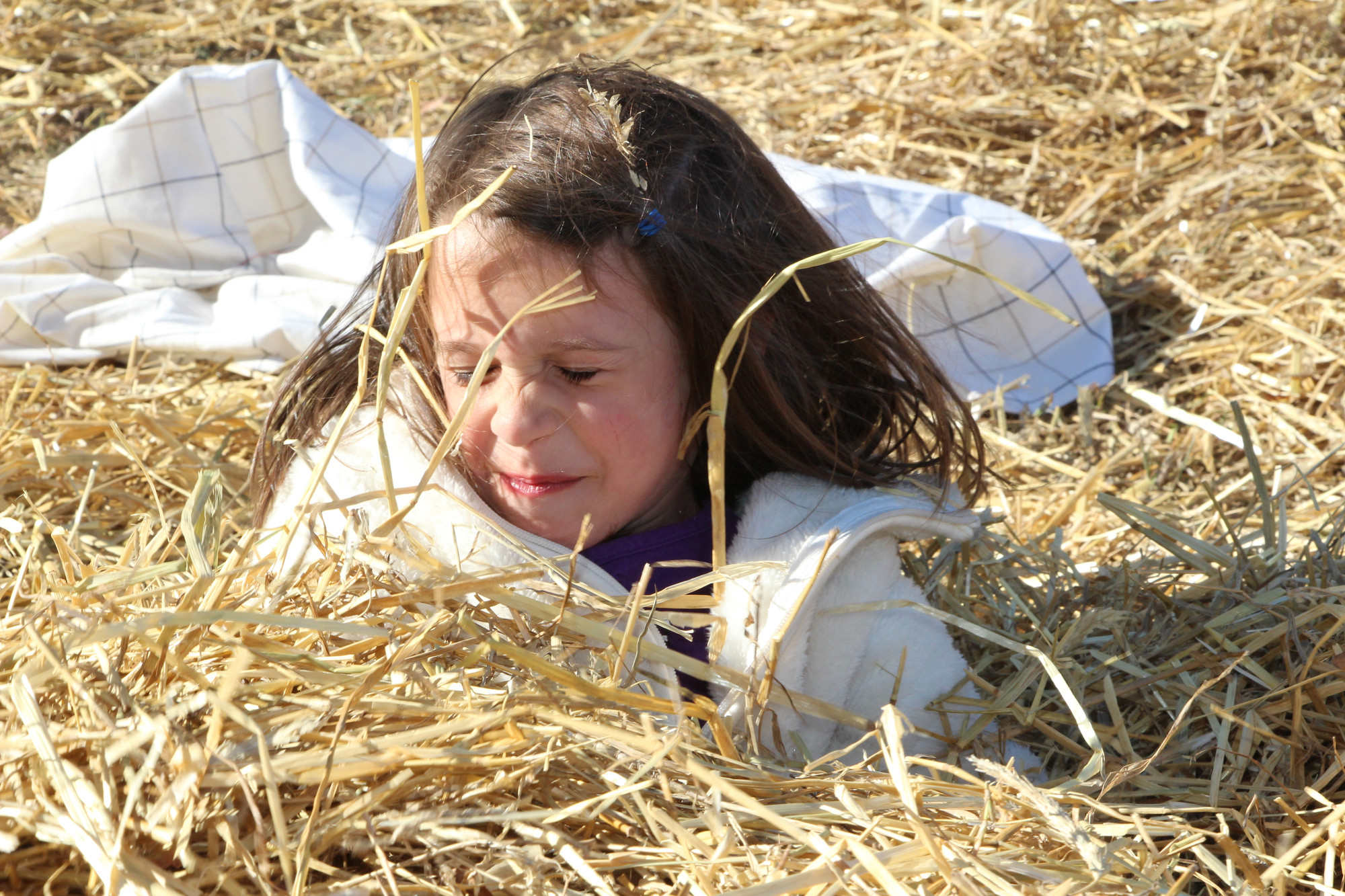 Maye Slate enjoyed playing in the hay at the Baldwin Halloween fest at Milburn Park.