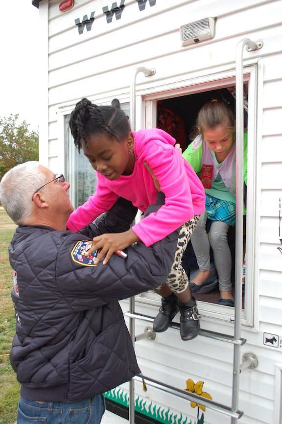 Richard Skellington helped third-grader Katianna Pierre out of the back of the fire safety trailer.
