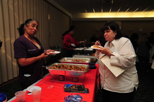 Norma jean singh, of Lynbrook Restorative, served up a Cajun shrimp dish to Linda Stephenson of the Lynbrook Chamber.